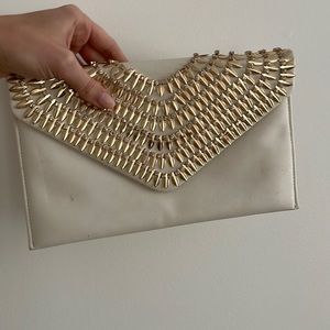 White and gold clutch bag